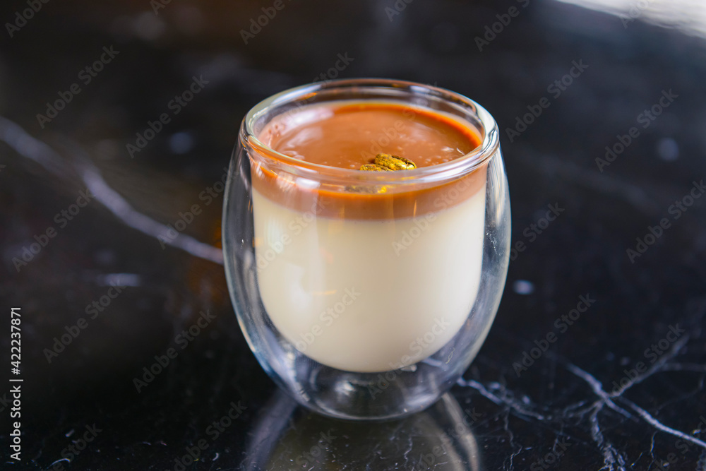 Chocolate coffee pudding in a small glass over lack table in restaurant or cafe. Blurred background. Chocolate coffee pudding in a small glass over lack table in restaurant or cafe. Blurred background.