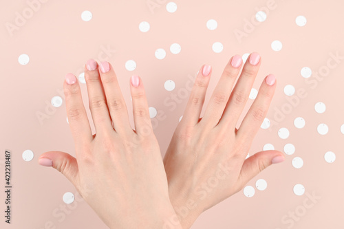 Beautiful woman manicure on creative pink background.