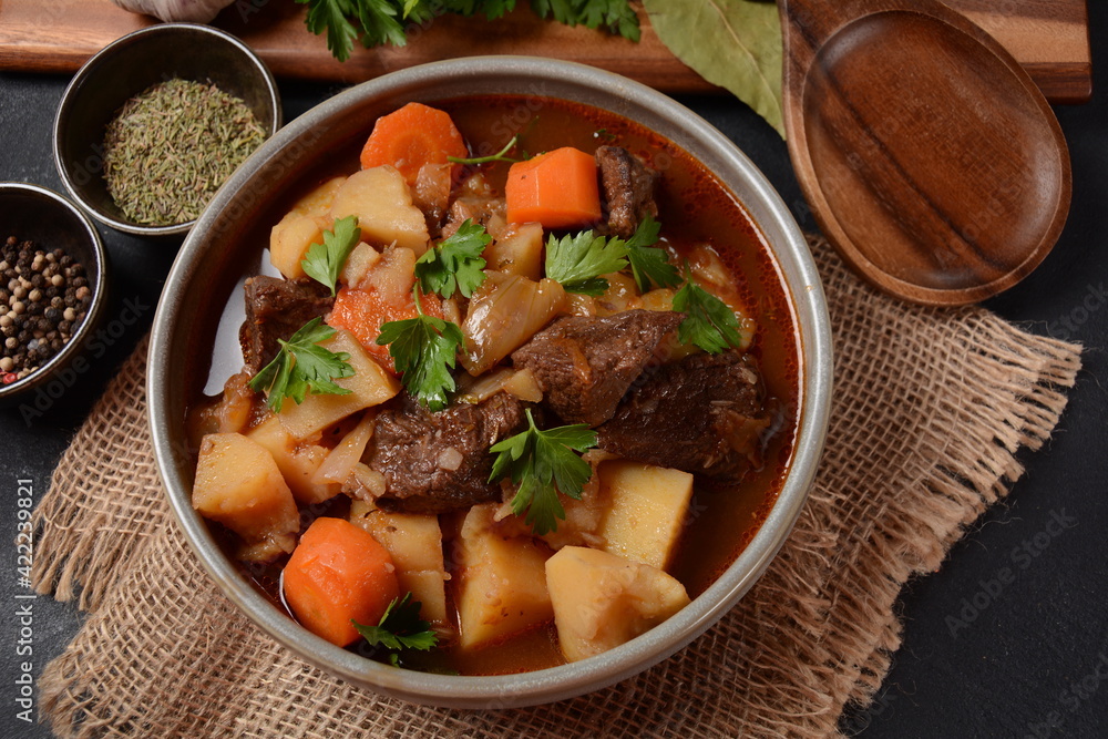 Irish stew made with beef, potatoes, carrots and herbs. Traditional St.Patrick's day dish, stewed in dark Guinness beer Irish stew made with beef, potatoes, carrots and herbs. Traditional St.Patrick's day dish, stewed in dark Guinness beer
