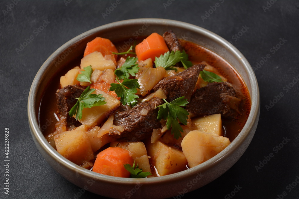 Irish stew made with beef, potatoes, carrots and herbs. Traditional St.Patrick's day dish, stewed in dark Guinness beer Irish stew made with beef, potatoes, carrots and herbs. Traditional St.Patrick's day dish, stewed in dark Guinness beer