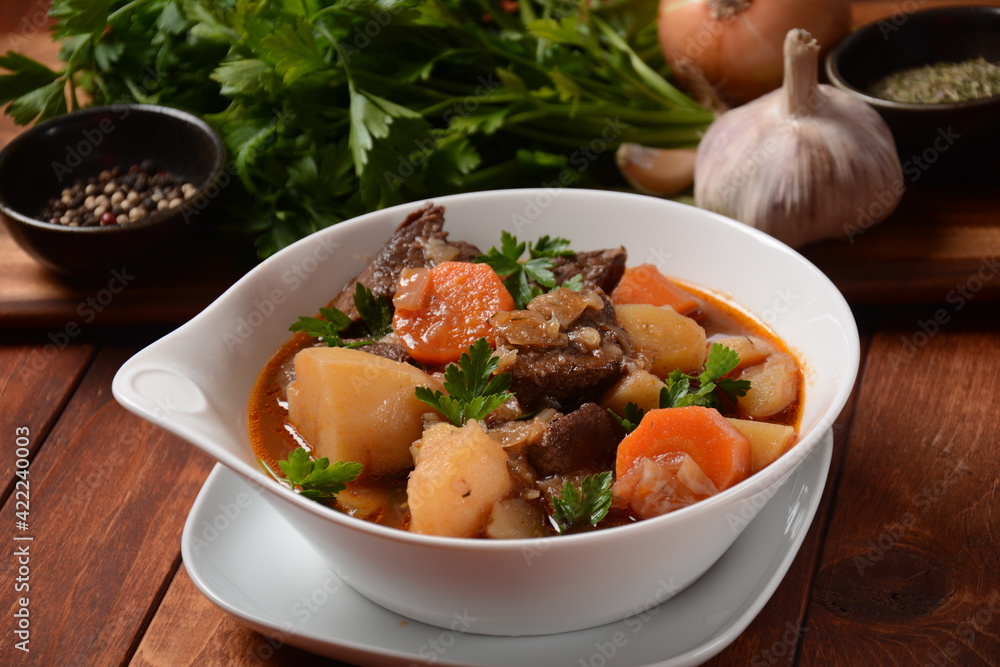 Irish stew made with beef, potatoes, carrots and herbs. Traditional St.Patrick's day dish, stewed in dark Guinness beer Irish stew made with beef, potatoes, carrots and herbs. Traditional St.Patrick's day dish, stewed in dark Guinness beer