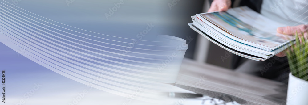 Φωτογραφία Male hands holding magazines; panoramic banner