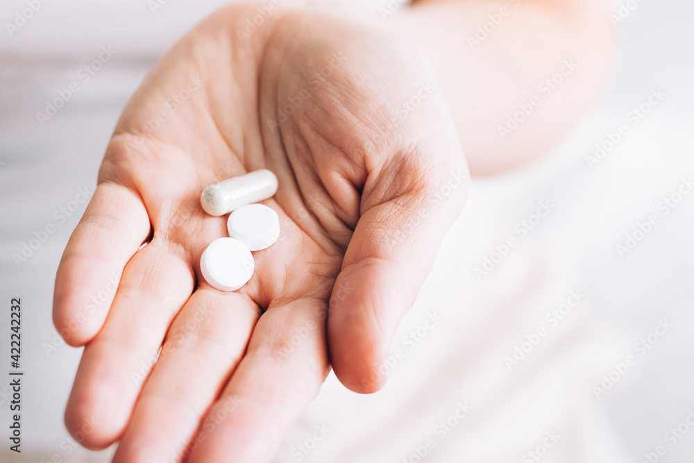 Medical pills tablets lie in woman's hand. Health and medicine. Selective focus Medical pills tablets lie in woman's hand. Health and medicine. Selective focus