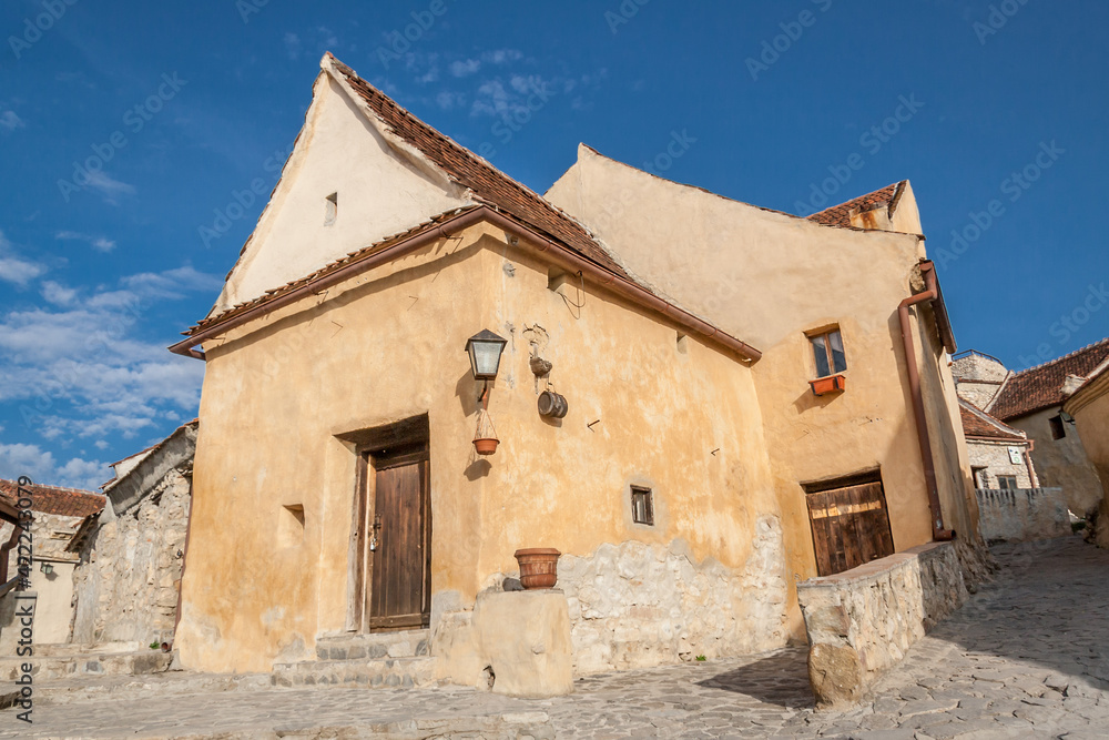 Inside courtyard and old houses of The Rasnov Citadel, little medieval fortress in traditional romanian style near Brasov city. Traditional medieval house in Transylvania region of Romania.