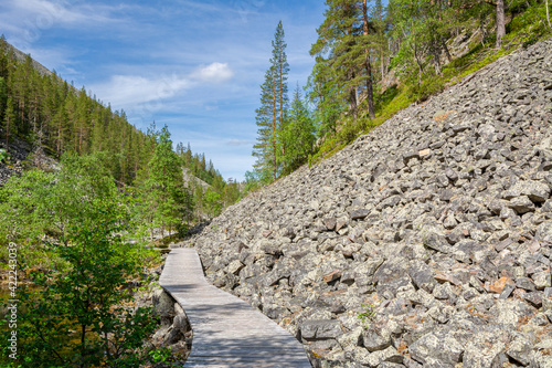 View of The Pyha-Luosto National Park in summer, wooden walkway and rocks, Lapland, Finland