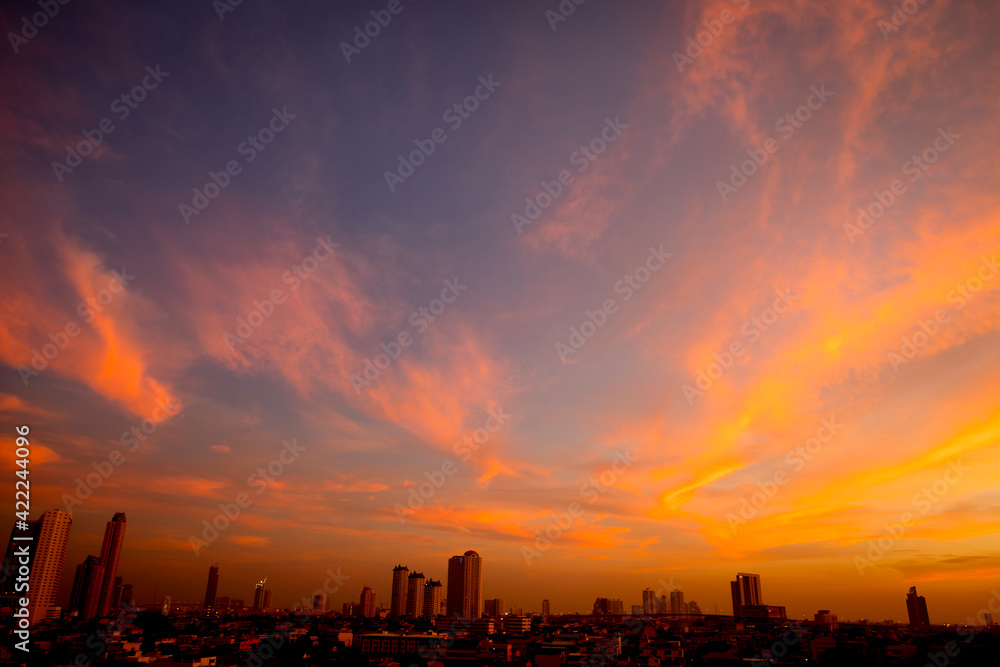 Sunset sky with city in the shadow Sunset sky with city in the shadow