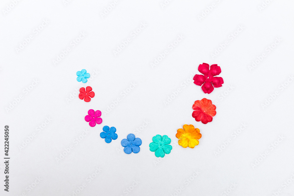 Colorful Paper flower arrange in half circle on white background, greeting card background idea, happy spring season