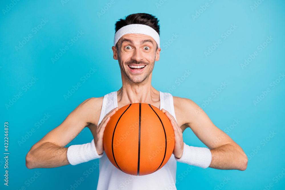 Photo of young excited man happy positive smile hold ball ready to play isolated over blue color background