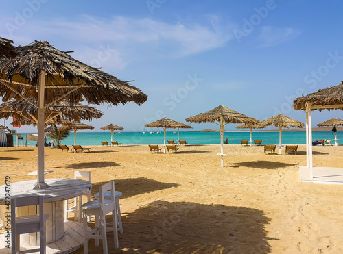 Beach bar on the shores of Atlantic Ocean, Cape Verde Island. Traditional style decorations reflecting tropical climate. Selective focus on the furniture, blurred background.