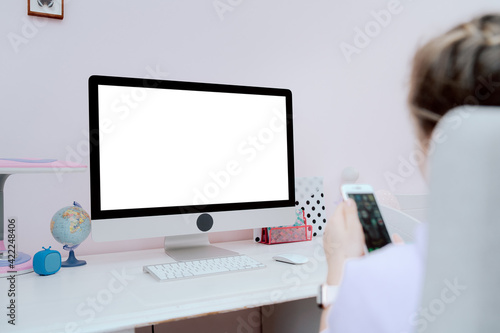 Monitor standing on white desk in teenage girl's room with copy space.