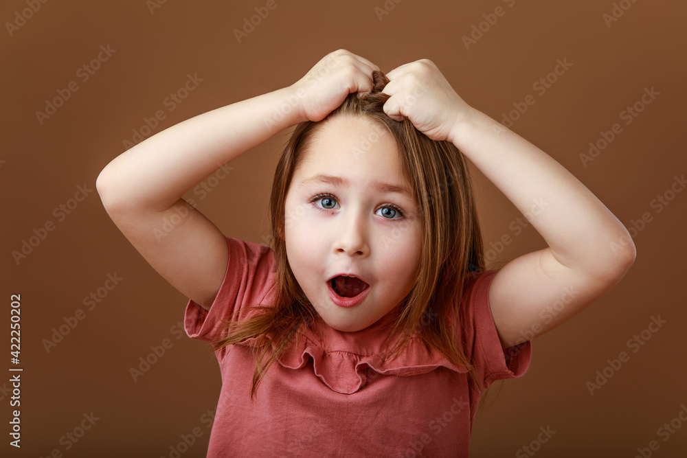 Girl clutching her head in surprise Girl clutching her head in surprise
