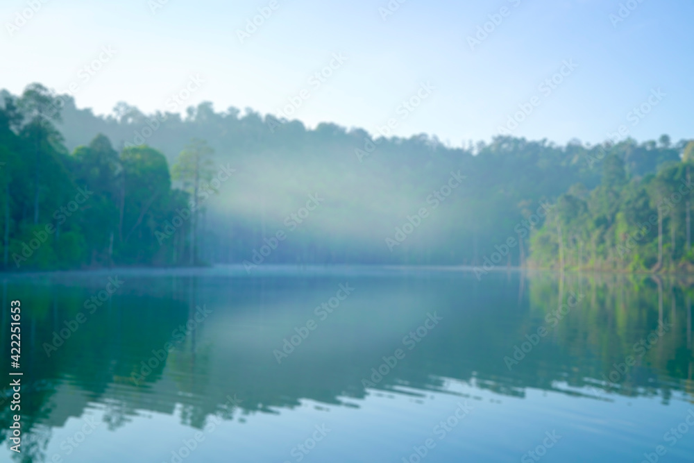 Defocused bokeh background of forest and lake with morning fog. Defocused bokeh background of forest and lake with morning fog.