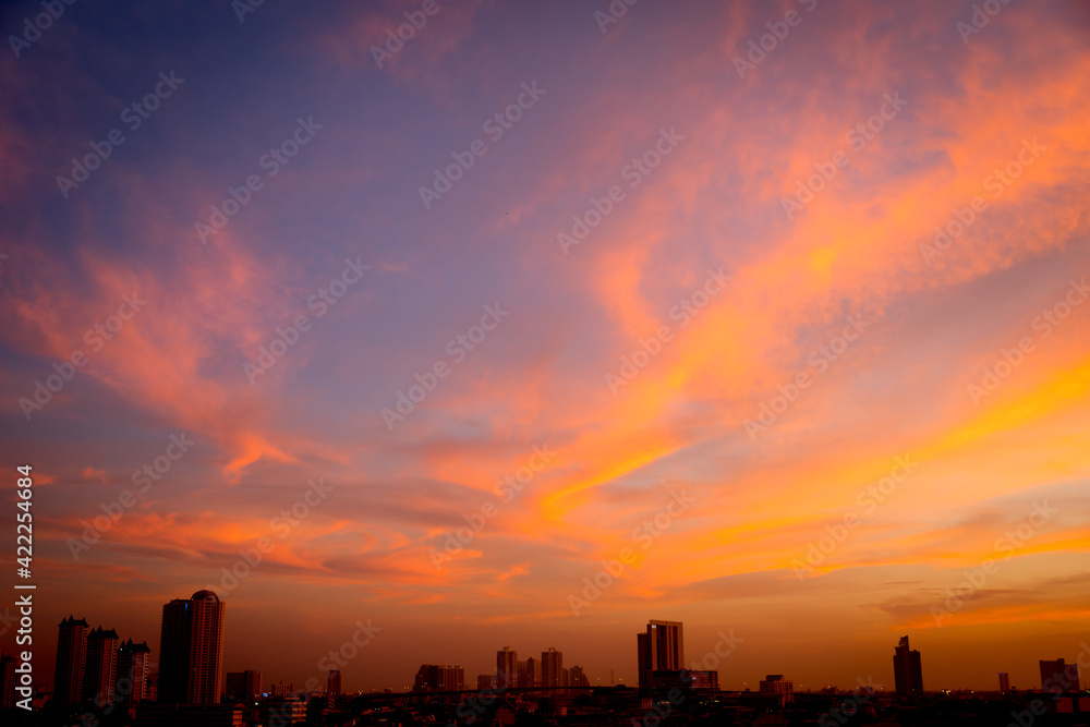 Sunset sky with city in the shadow