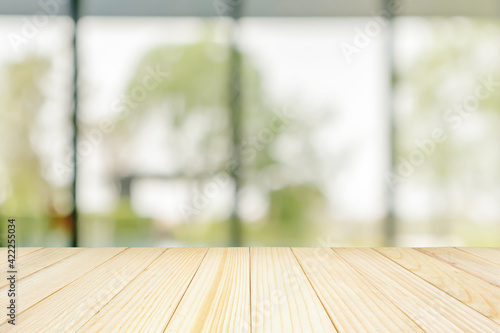 Empty wood table top with blurred window background for product display