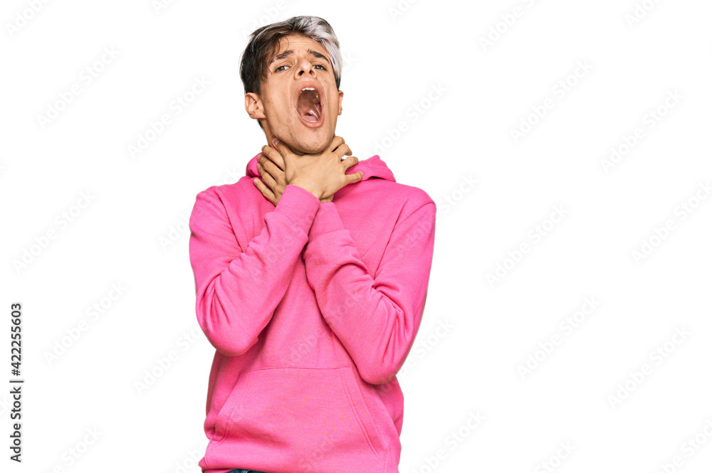 Young hispanic man wearing casual pink sweatshirt shouting and suffocate because painful strangle. health problem. asphyxiate and suicide concept. Young hispanic man wearing casual pink sweatshirt shouting and suffocate because painful strangle. health problem. asphyxiate and suicide concept.