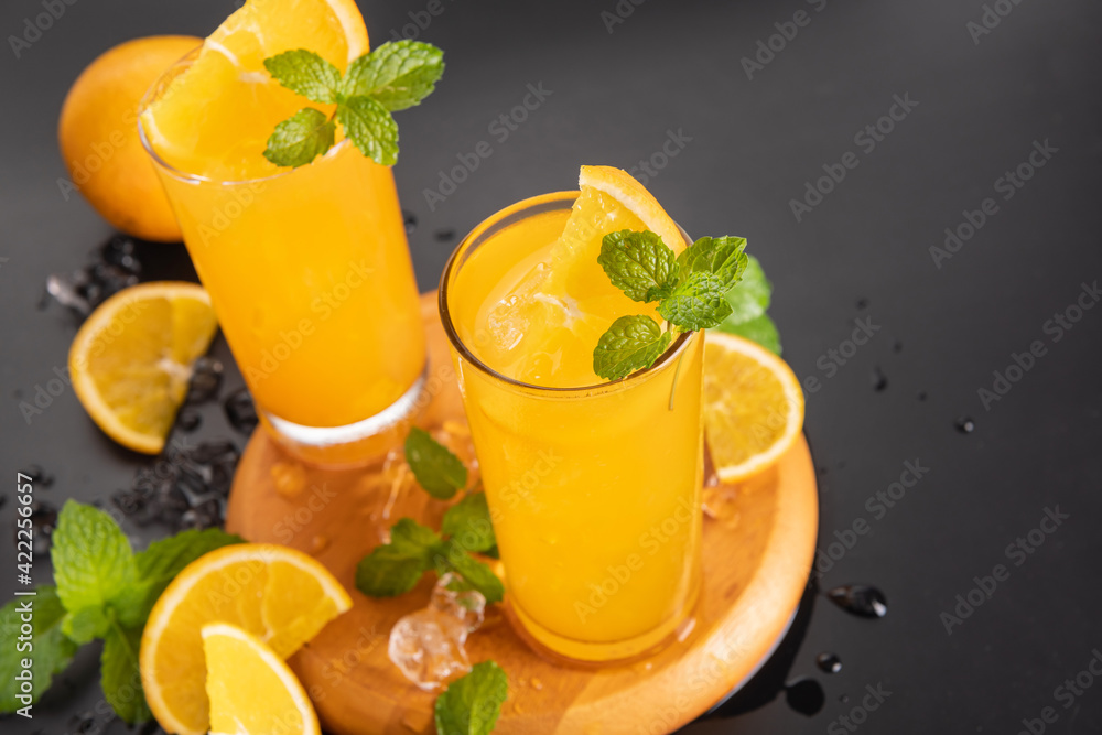 Fototapeta premium Fresh orange juice in glass with mint, fresh fruits. selective focus.