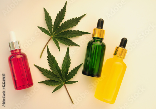 Cannabis leaves, cbd oil, cosmetic cream. Marihuana extract in cosmetology. Flat lay, powder background. Home relaxation, spa recreation, pastime therapy.