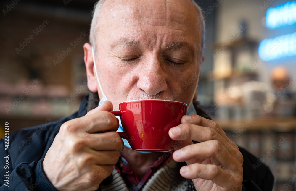 senior man enjoying cup of coffee in cafe senior man enjoying cup of coffee in cafe