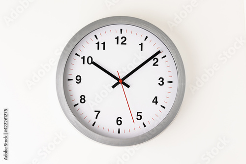 Large white clock, black numbers, red needle Set a timer on the white table