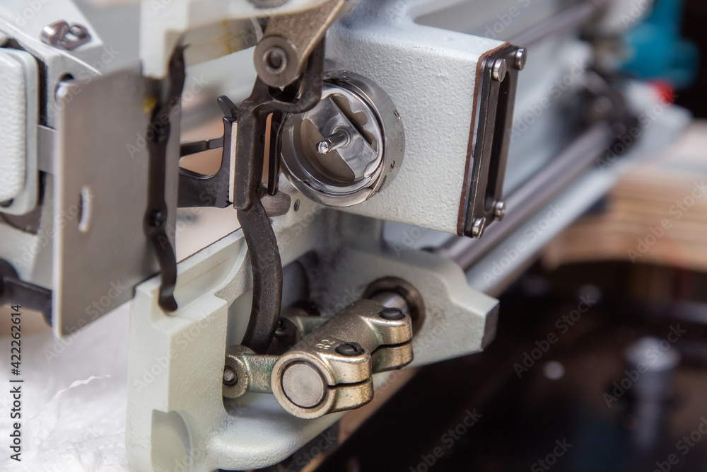 Parts and components of sewing machine tilted to one side during repair