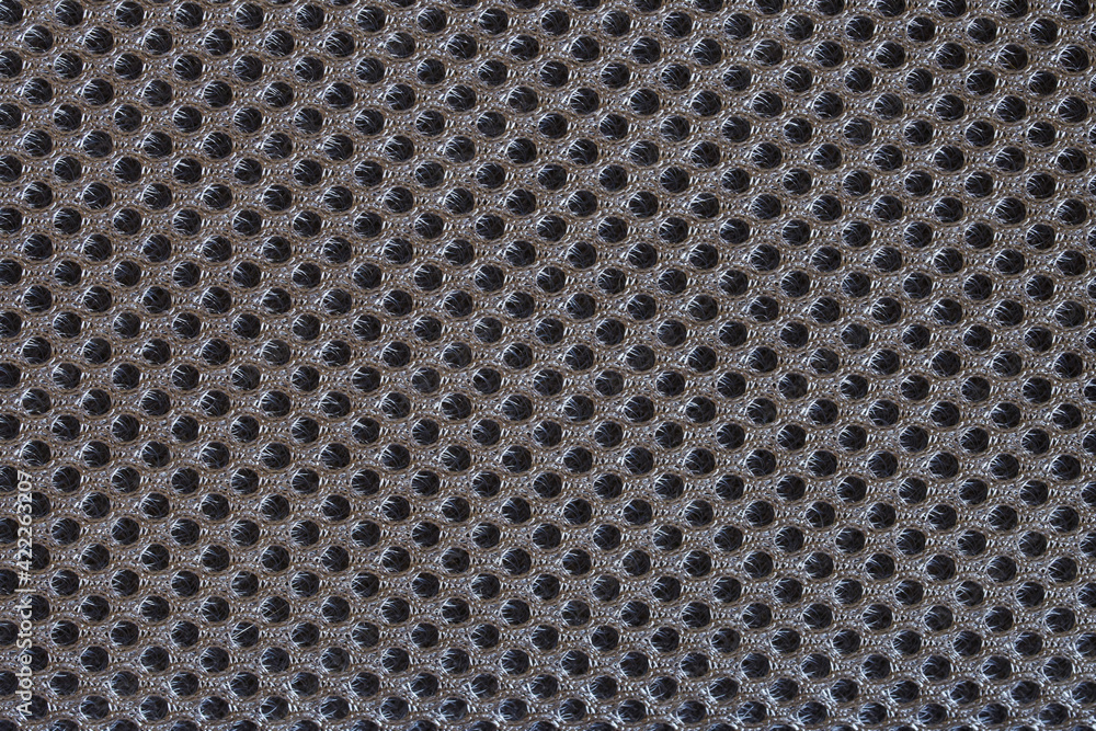Dark gray textile surface with many small meshes. Orthopedic insert in the back of a modern backpack. Backdrop or background Dark gray textile surface with many small meshes. Orthopedic insert in the back of a modern backpack. Backdrop or background