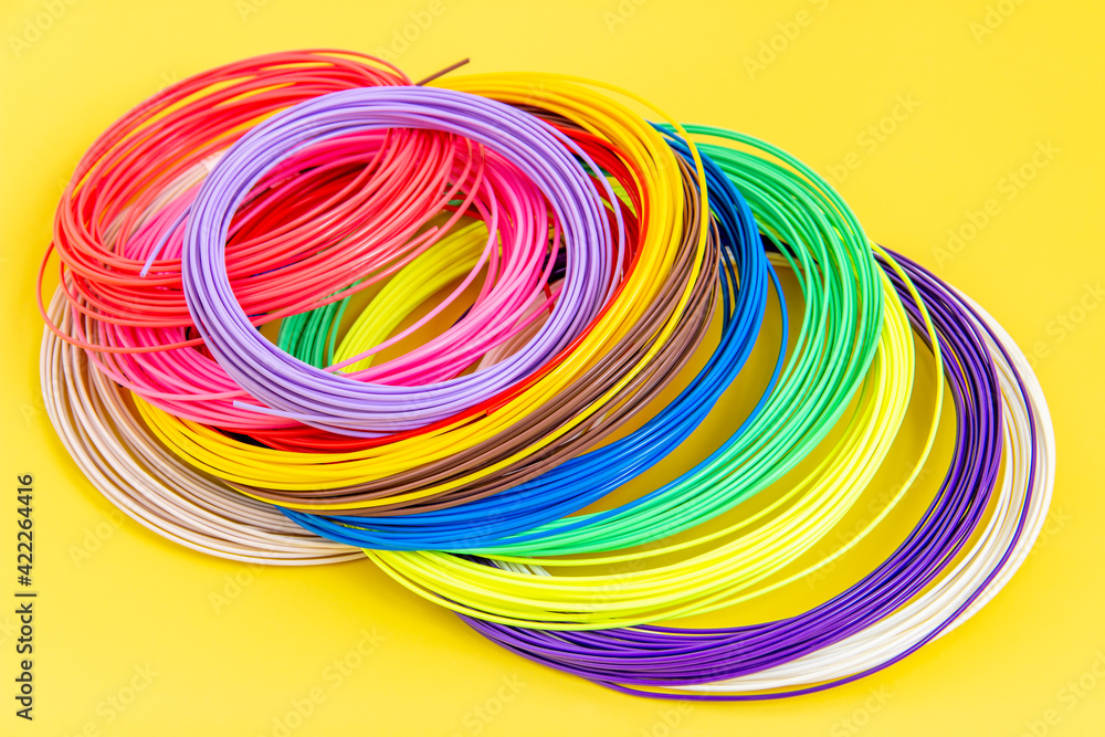 Kit colored PLA and ABS plastic filament for 3D printer and pen. Hobby for children. Close-up.