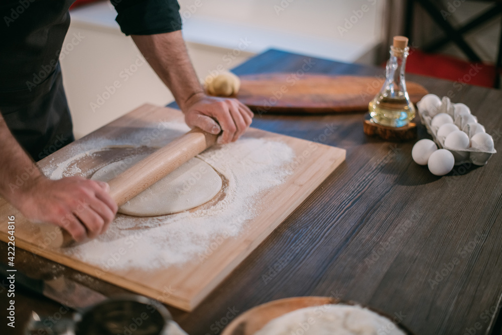 A male chef prepares noodles at home in the kitchen. A male chef prepares noodles at home in the kitchen.