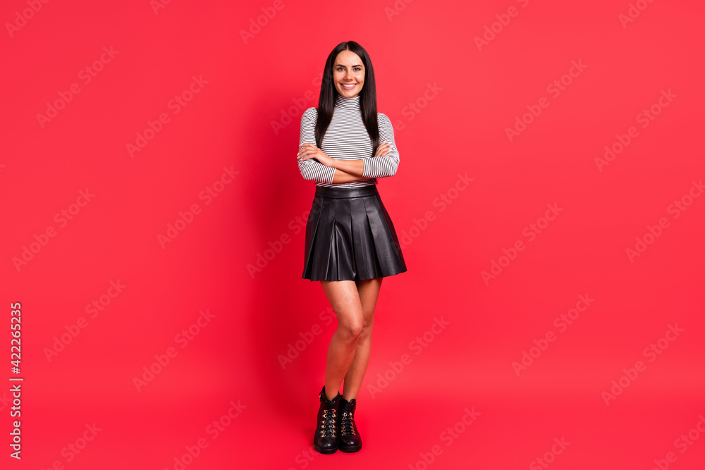 Full size photo of young beautiful pretty smiling good mood girl with folded hands isolated on red color background