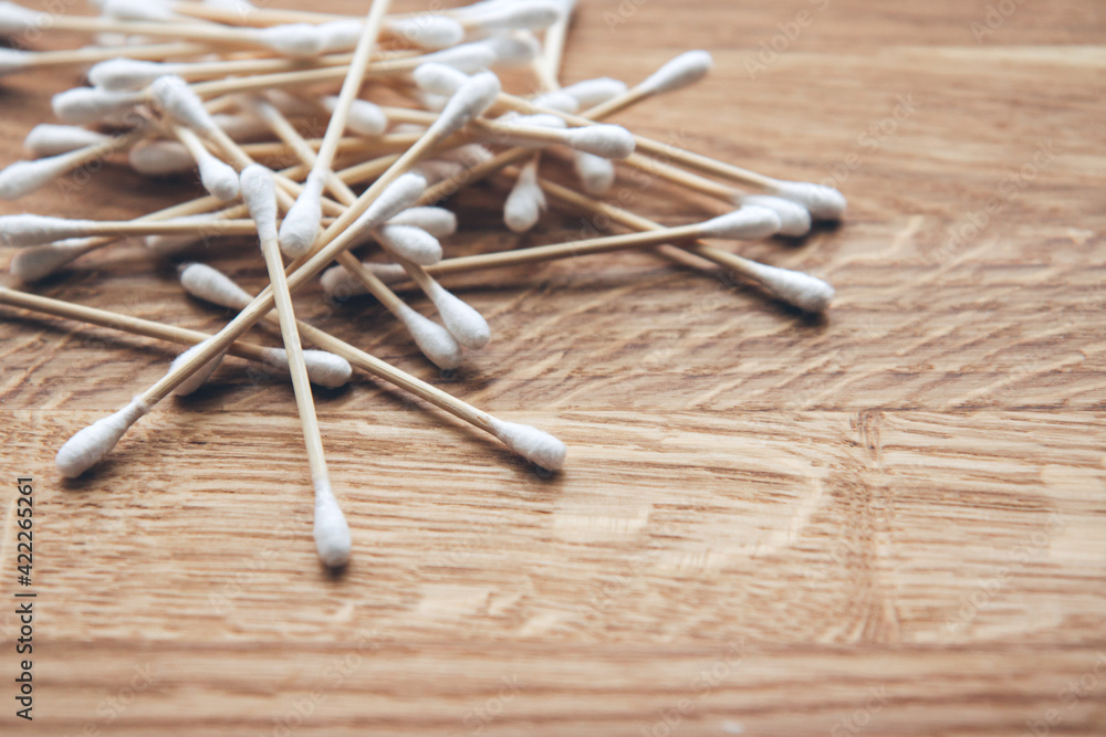Set of bamboo cotton swabs on wooden background. Set of bamboo cotton swabs on wooden background.