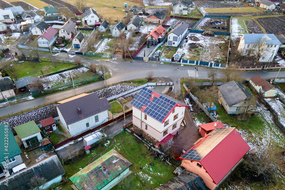 Aerial view of surface of blue photovoltaic solar panels mounted on building roof for producing clean ecological electricity. Production of renewable energy concept.