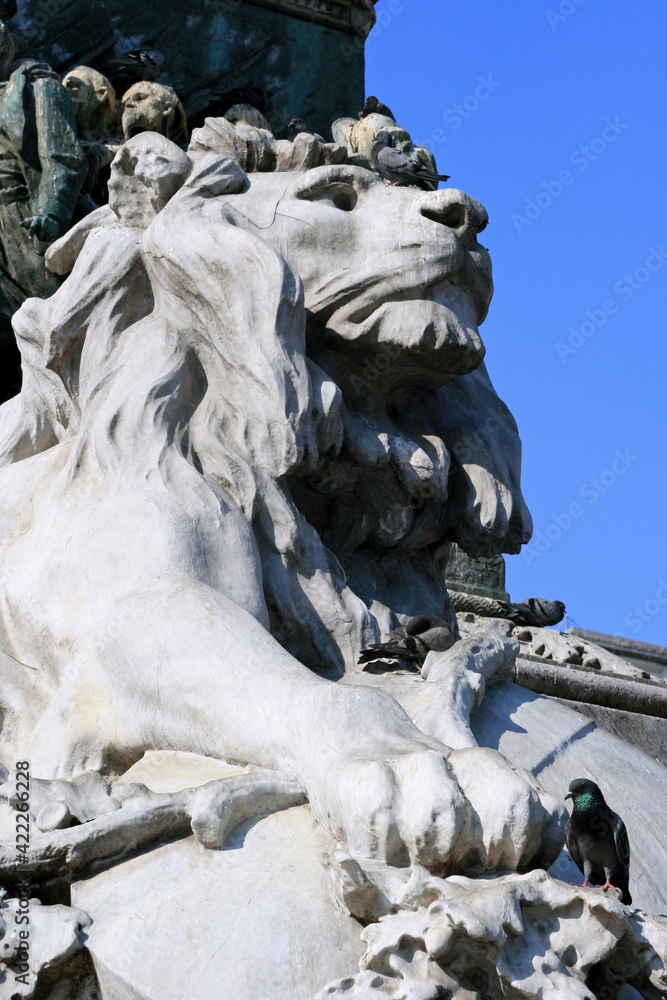 statue of a lion at duomo square in milan (italy)