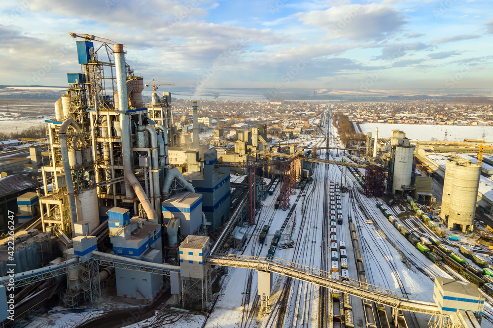Aerial view of cement plant with high factory structure at industrial production area. Aerial view of cement plant with high factory structure at industrial production area.