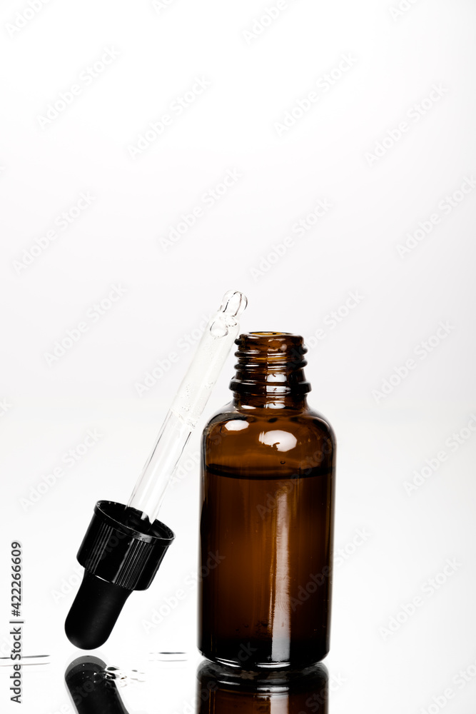 Face skin and body care concept, Healthy natural cosmetics in dark glass reusable bottles. Hyaluronic acid with pipette. Face skin and body care concept, Healthy natural cosmetics in dark glass reusable bottles. Hyaluronic acid with pipette.