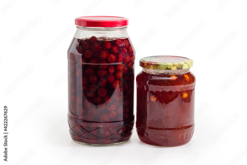Apricot jam and cherry jam in two glass jars Apricot jam and cherry jam in two glass jars