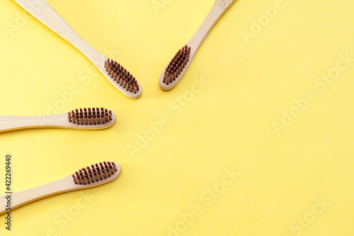Dental care. Bamboo toothbrush on a yellow background.  Copy space.Ecology. No plastic. 