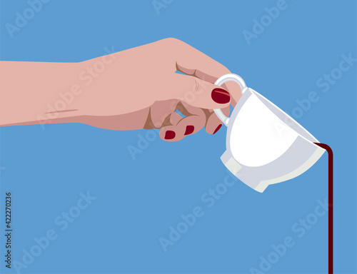 Female hand holding a white cup with pouring coffee on blue background