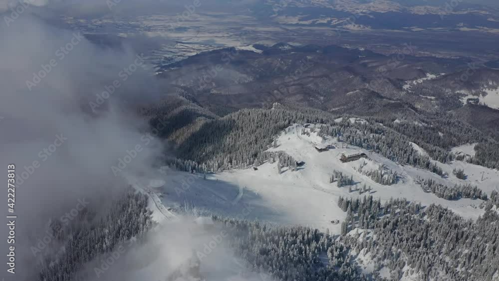 4K Aerial landscape view of Poiana Brasov ski resort from Transylvania Romania during a beautiful winter day. Sports and massive snow. 4K Aerial landscape view of Poiana Brasov ski resort from Transylvania Romania during a beautiful winter day. Sports and massive snow.