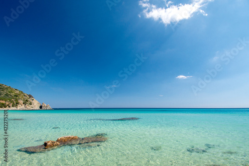 crystal clear water and white sand with blue sky for background