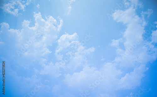 Blue sky white clouds floating in the sky and The light from the sun shines through the beautiful clouds.for background concept.