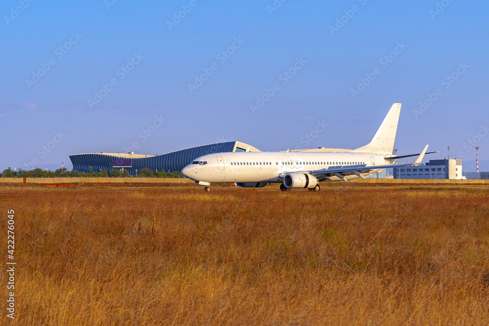Big passenger airplane drives along the runway in airport Big passenger airplane drives along the runway in airport