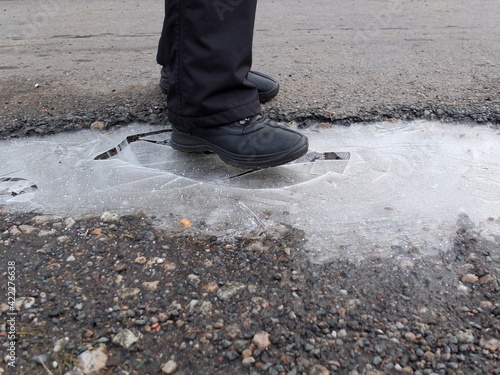 Woman Steps Into A Frozen Puddle