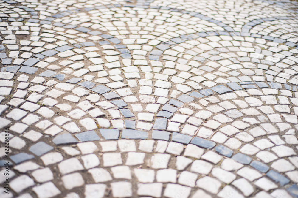 old style stone paving stones, old square stone tiles on the road and sidewalks, stone dirt road in the old town, laying slabs on the roads old style stone paving stones, old square stone tiles on the road and sidewalks, stone dirt road in the old town, laying slabs on the roads