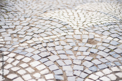 stone pavement texture, old square tiles on the road and sidewalk, old style stone paving stones, stone dirt road in the old town, paving slabs on the roads