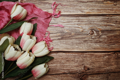 Tulip flower bouquet and scarf with space copy on wooden background