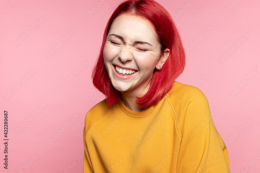 Headshot of cheerful modern young girl with dyed pink hairs, laughing closed eyes at funny joke feels overjoyed having wide snow-white smile straight teeth posing on rose studio background. Headshot of cheerful modern young girl with dyed pink hairs, laughing closed eyes at funny joke feels overjoyed having wide snow-white smile straight teeth posing on rose studio background.