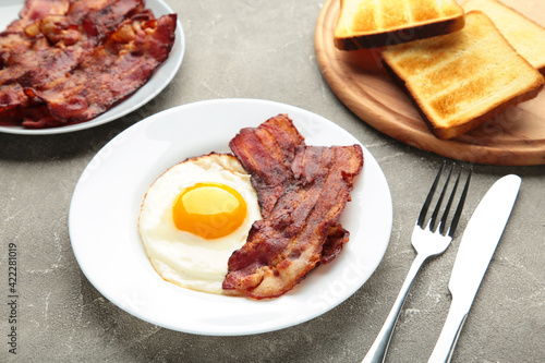 Eggs and bacon for breakfast on grey background. English breakfast.