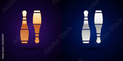 Gold and silver Bowling pin icon isolated on black background. Juggling clubs, circus skittles. Vector