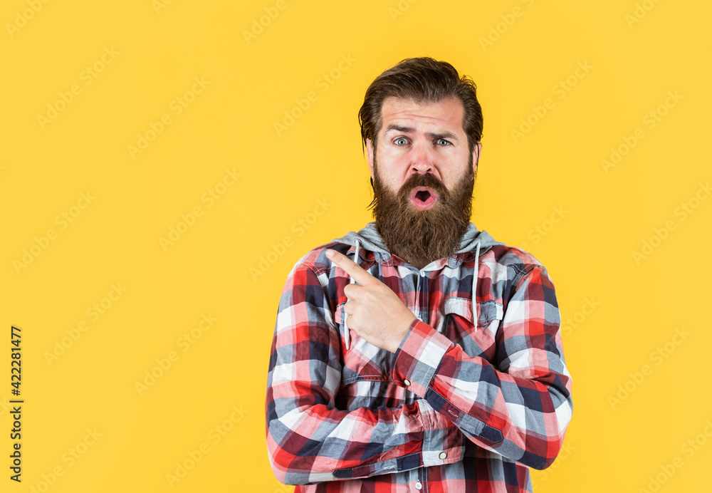 Obraz premium surprised stylish bearded guy with trendy hairstyle wear checkered shirt, surprise