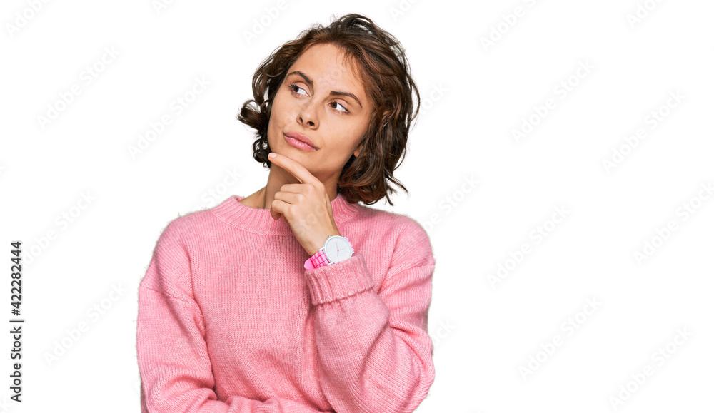 Young hispanic woman wearing casual clothes with hand on chin thinking about question, pensive expression. smiling with thoughtful face. doubt concept. Young hispanic woman wearing casual clothes with hand on chin thinking about question, pensive expression. smiling with thoughtful face. doubt concept.