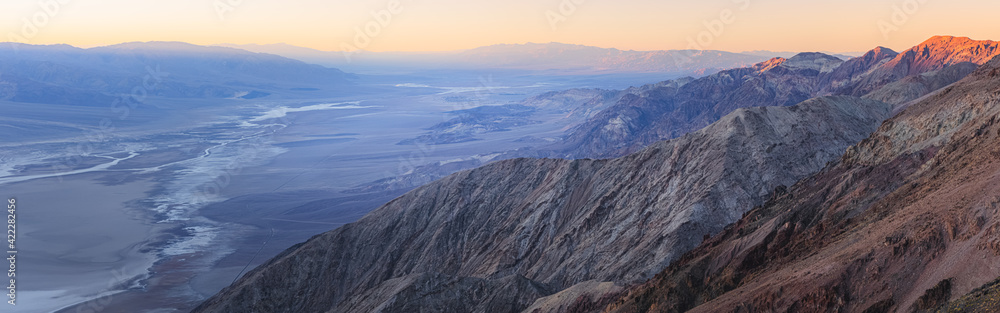 Panorama sunset or sunrise over the desert landscape of Badwater Basin salt flats from Dantes View in Death Valley National Park, California, USA.